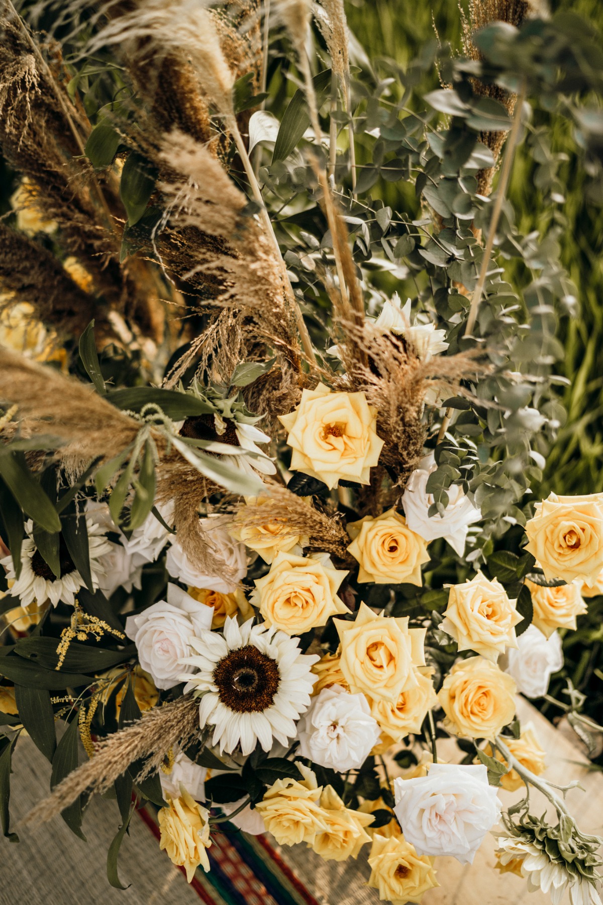 Yellow and white roses with pampas grass arrangement