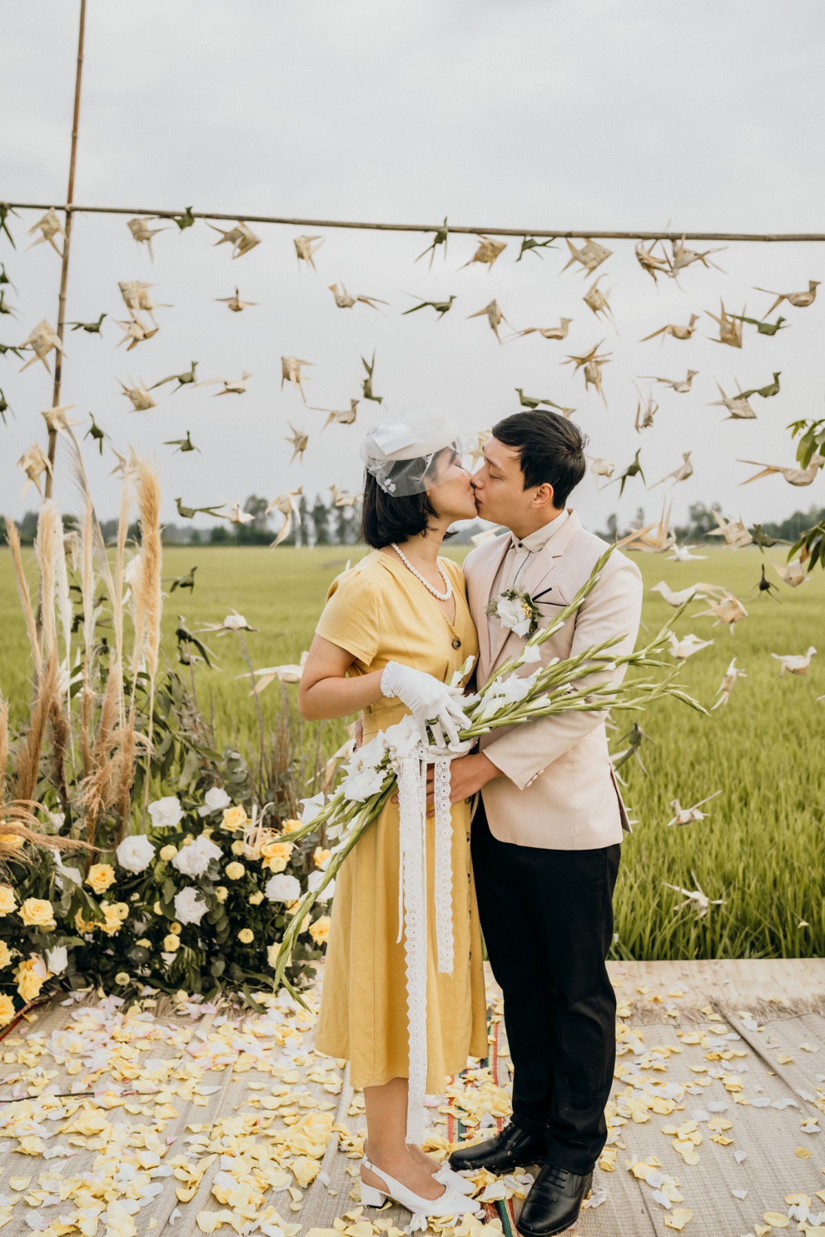 Bride and groom kissing at a charming outdoor wedding