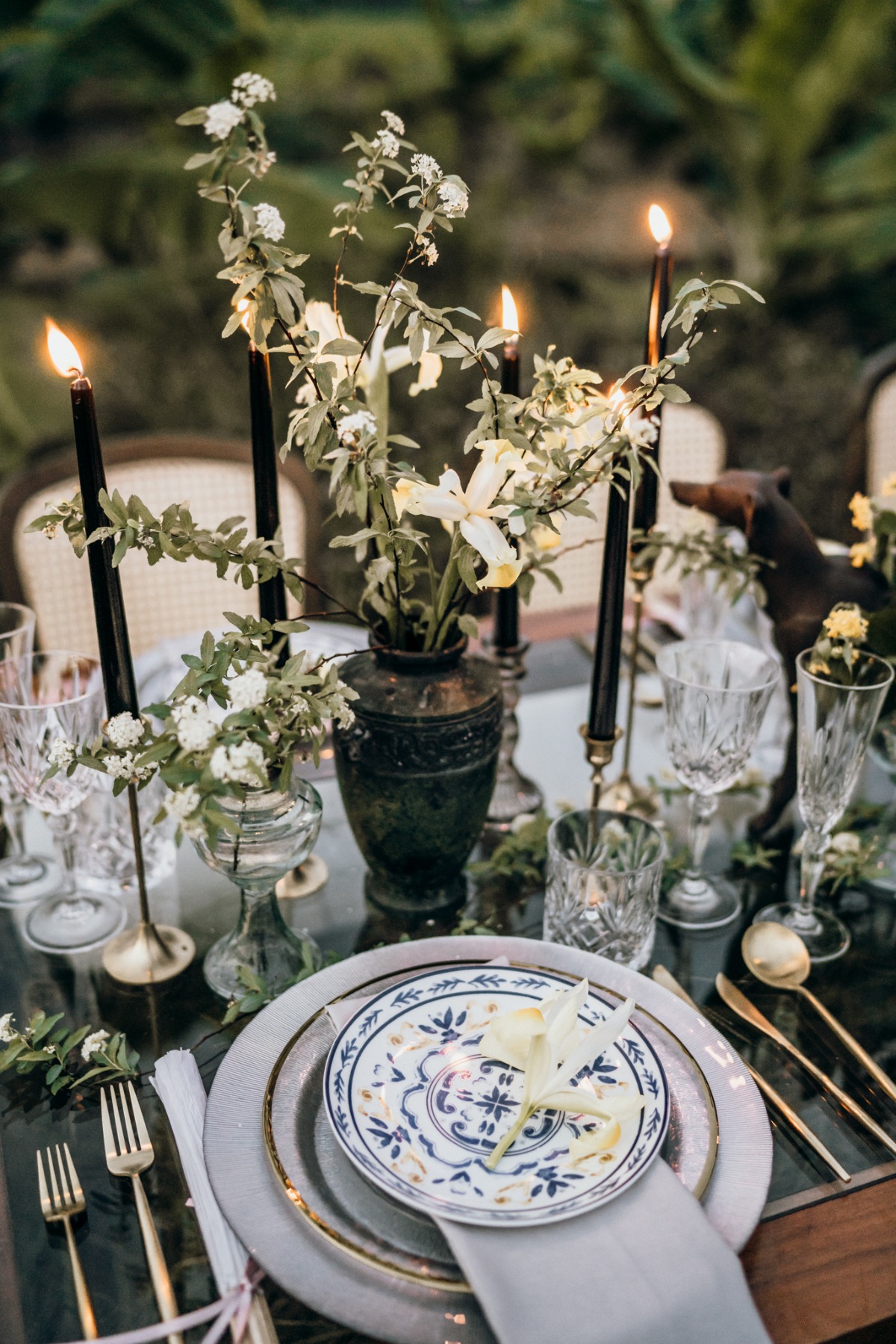 Elegant outdoor wedding table setting with candles and flowers