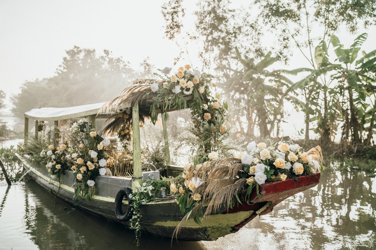 Decorated boat with white and yellow flowers on river