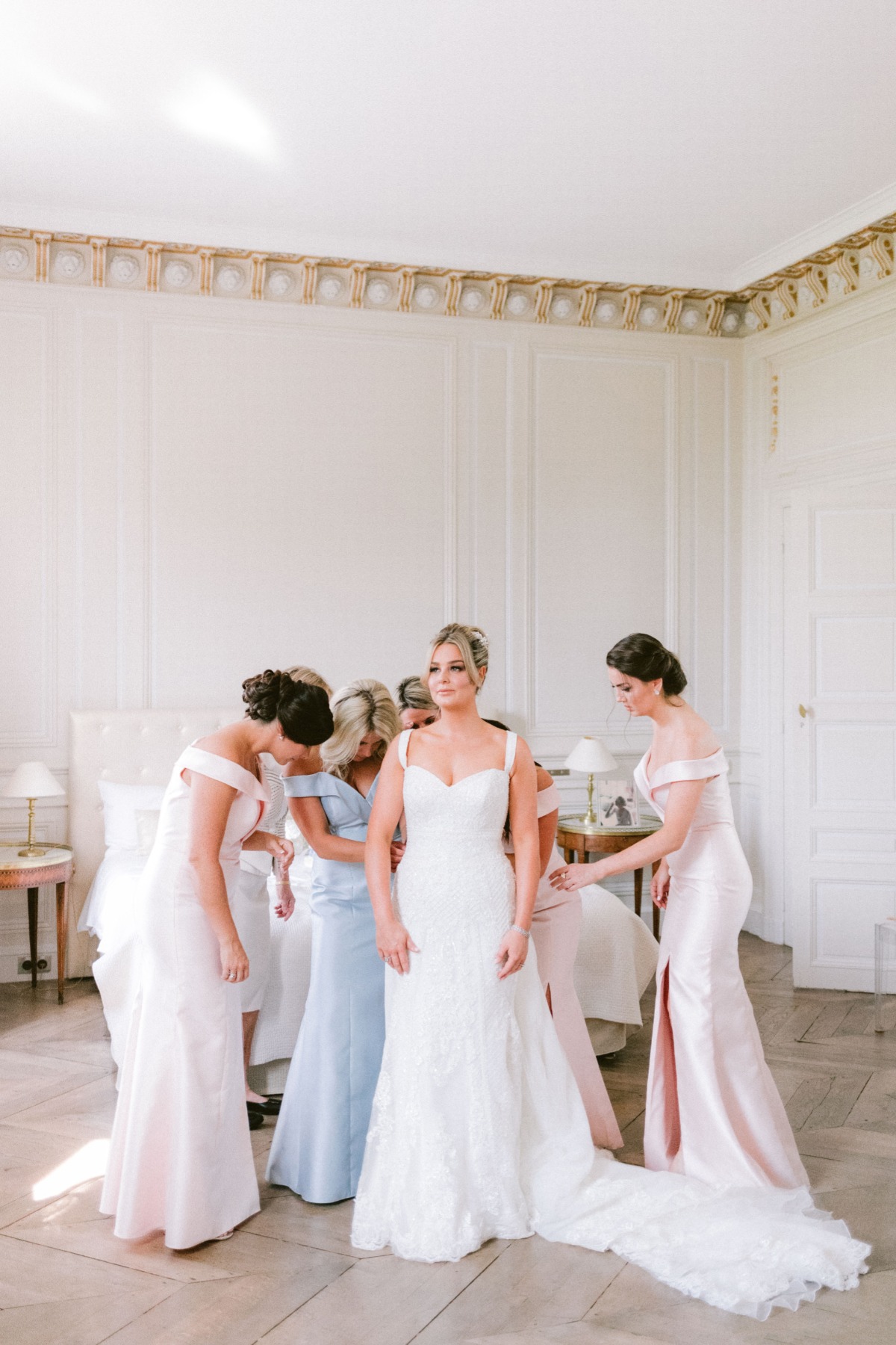 Bride and bridesmaids in a beautiful wedding gown getting ready