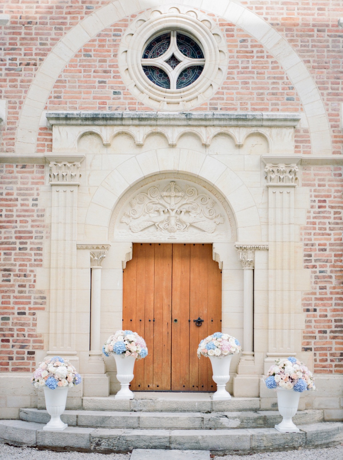 Church entrance with elegant wooden door and floral arrangements
