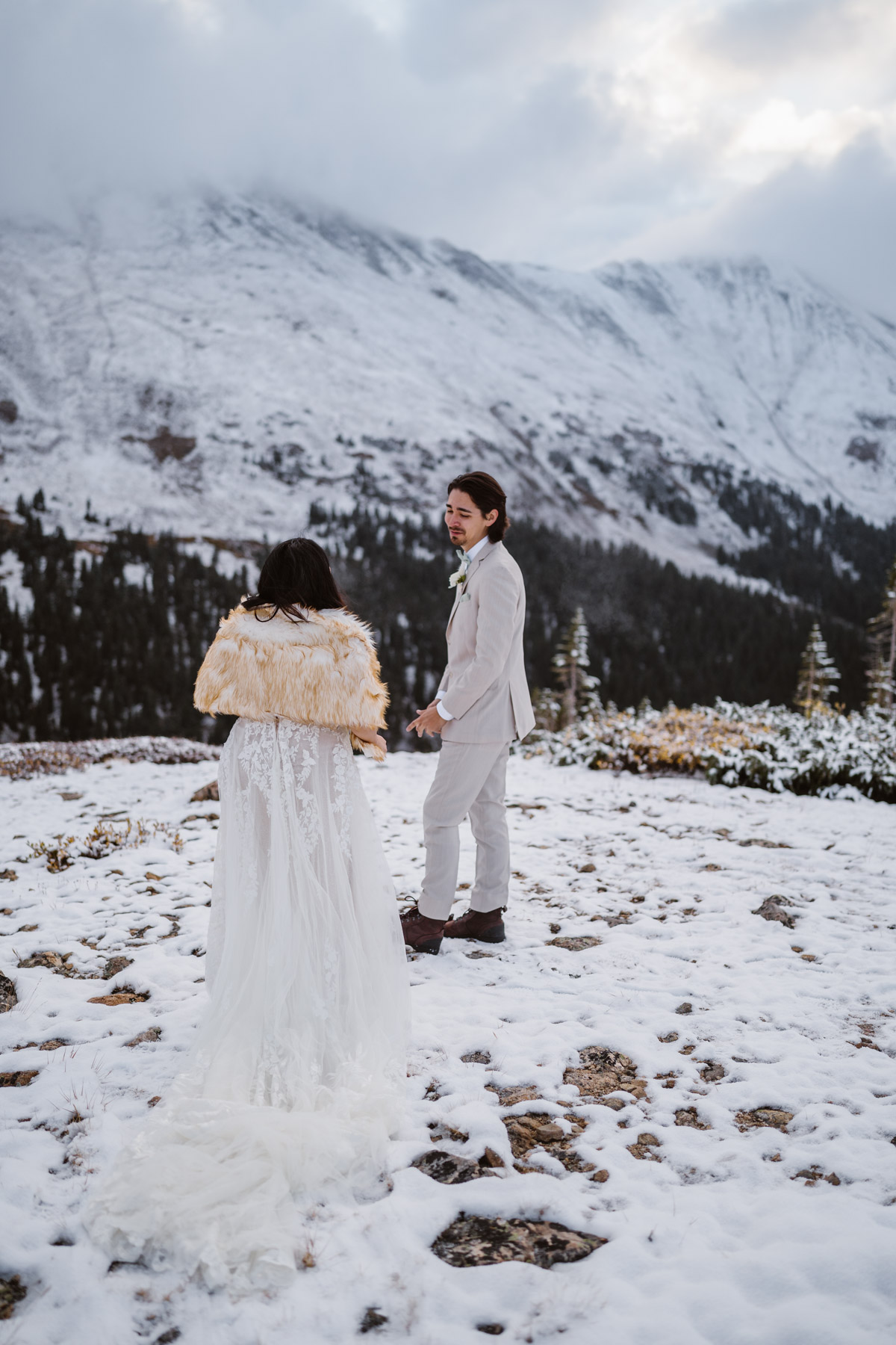 A newly married couple in a snowy mountain wedding ceremony