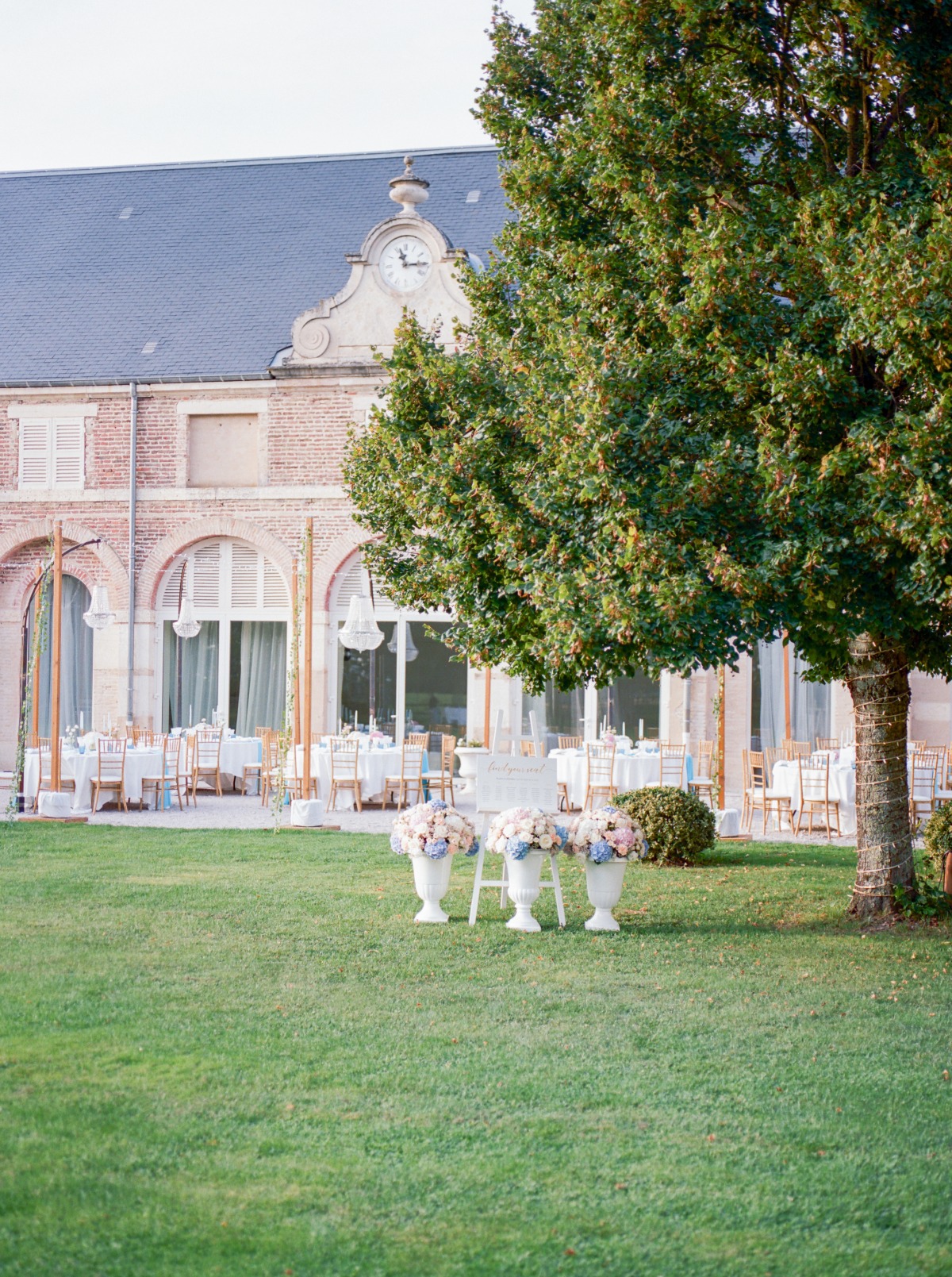 Outdoor wedding reception with flower vases in a garden