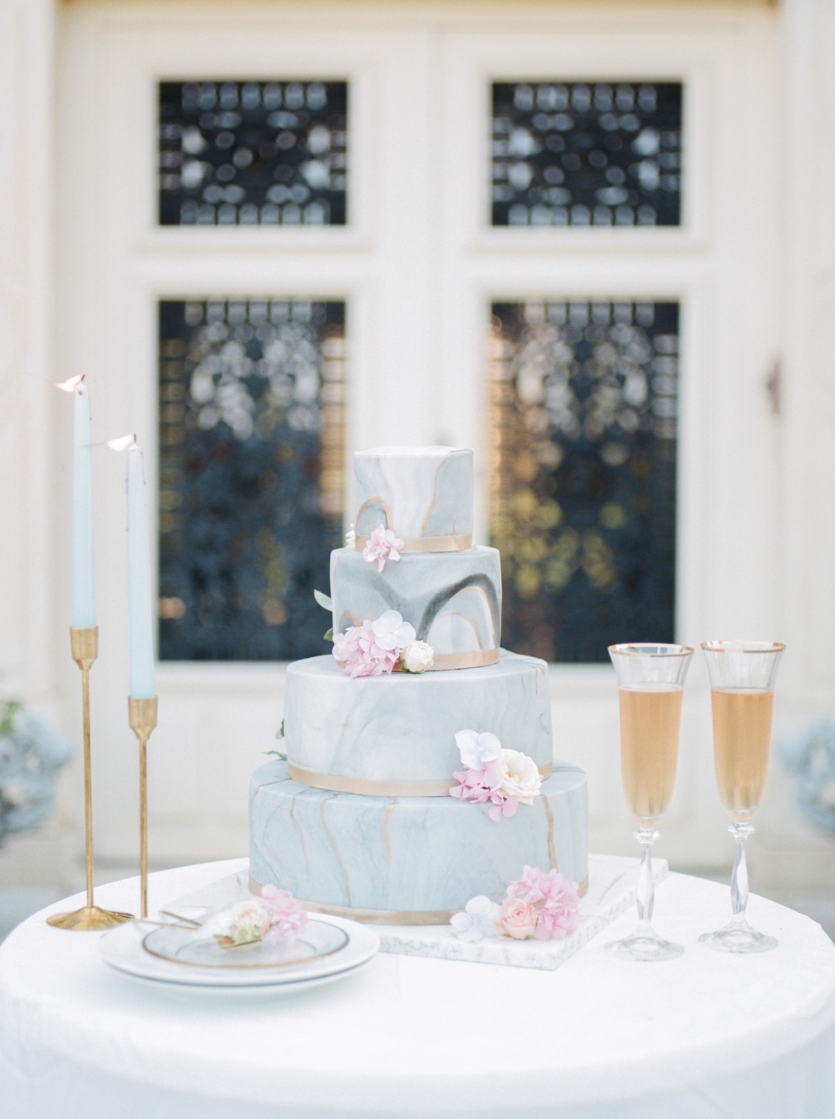 Elegant wedding cake with champagne flutes and soft floral decor