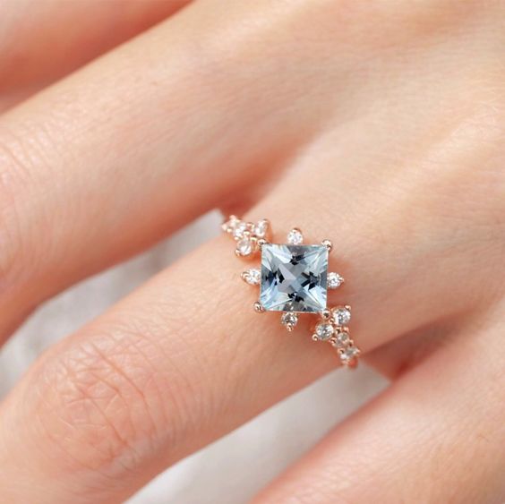 Elegant aquamarine ring on a finger, a beautiful jewelry detail