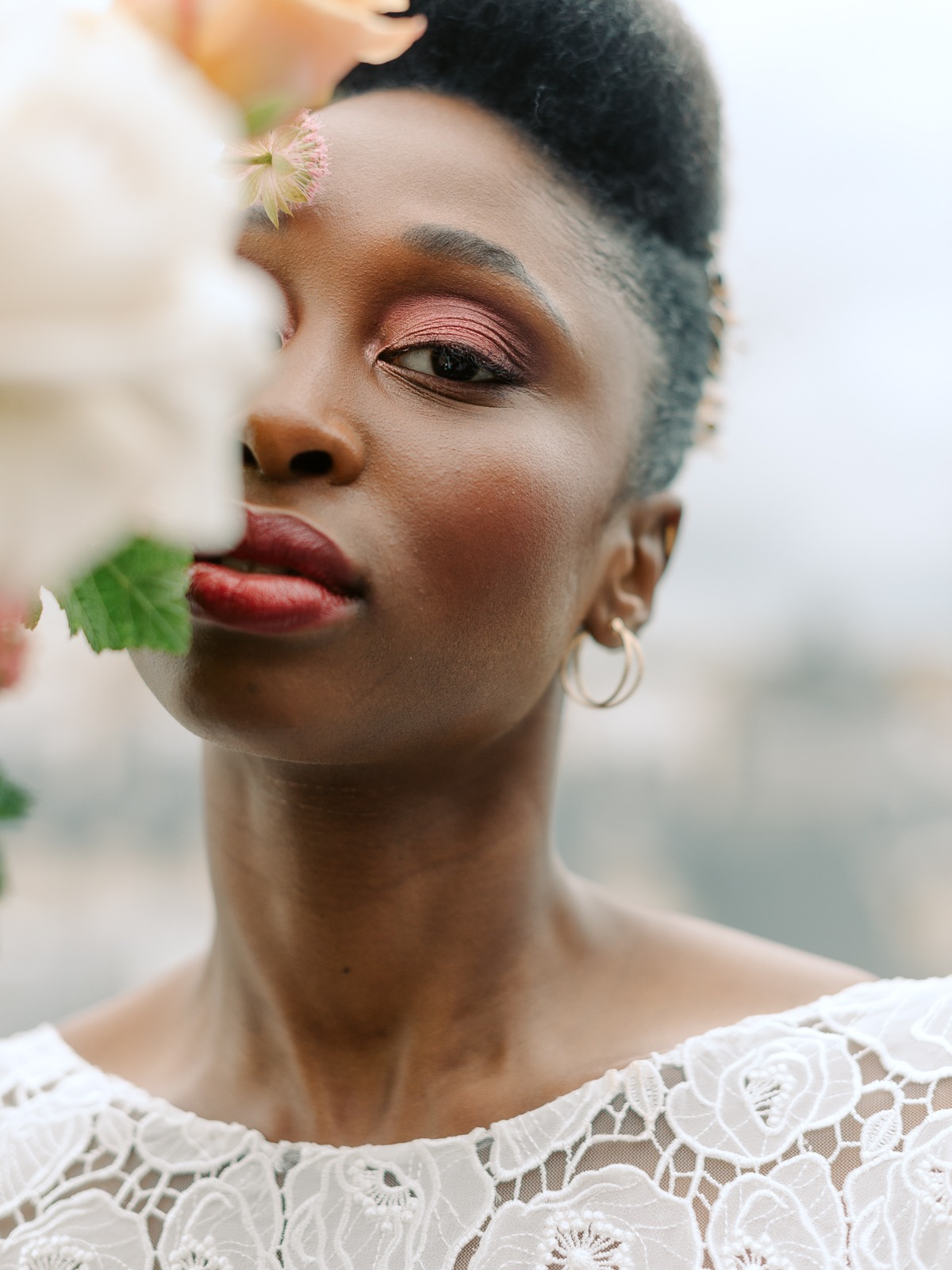 Beautiful Black woman with flower close-up, elegant and stylish