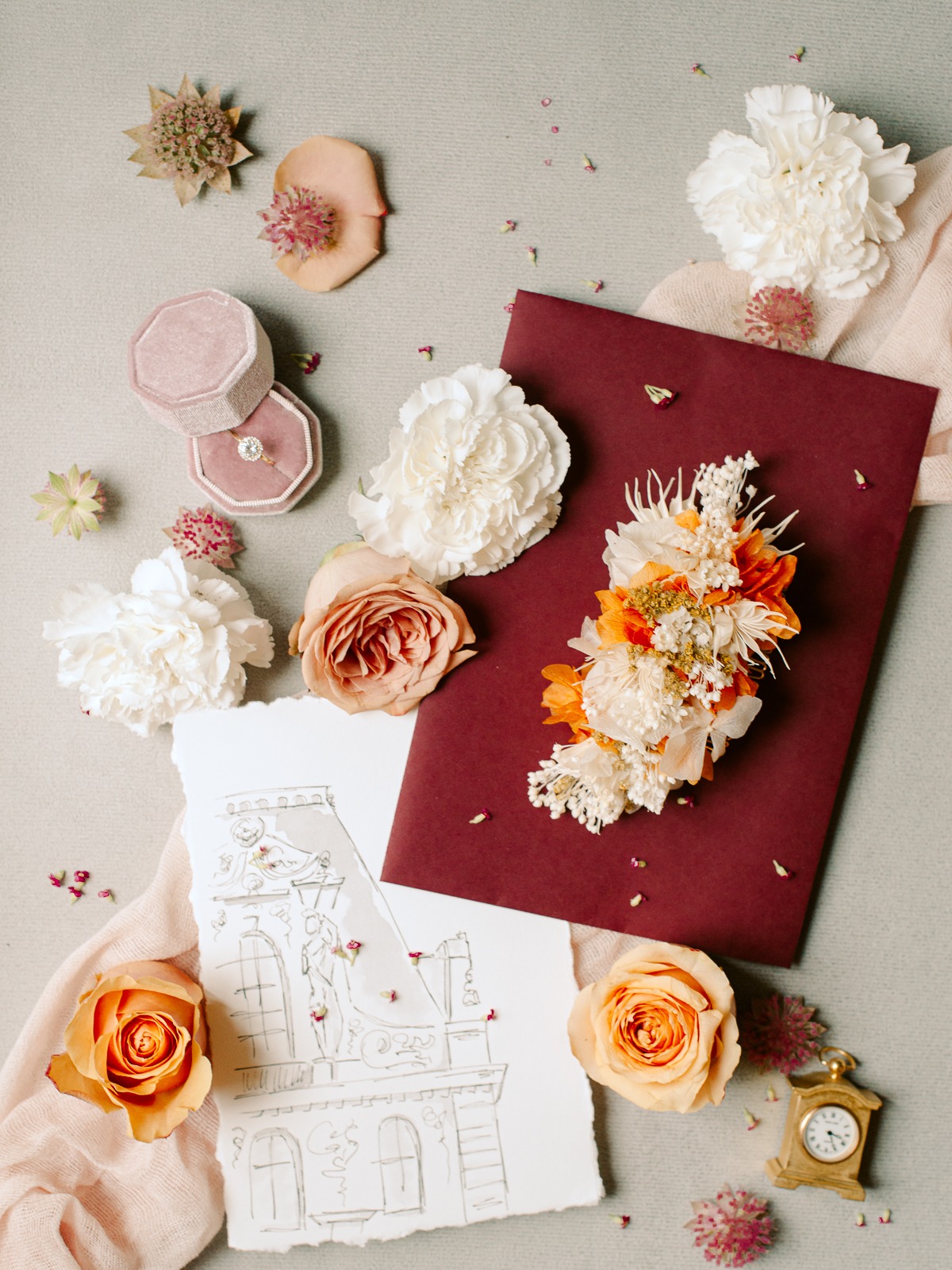 Romantic wedding theme with flowers, ring, and architectural sketch