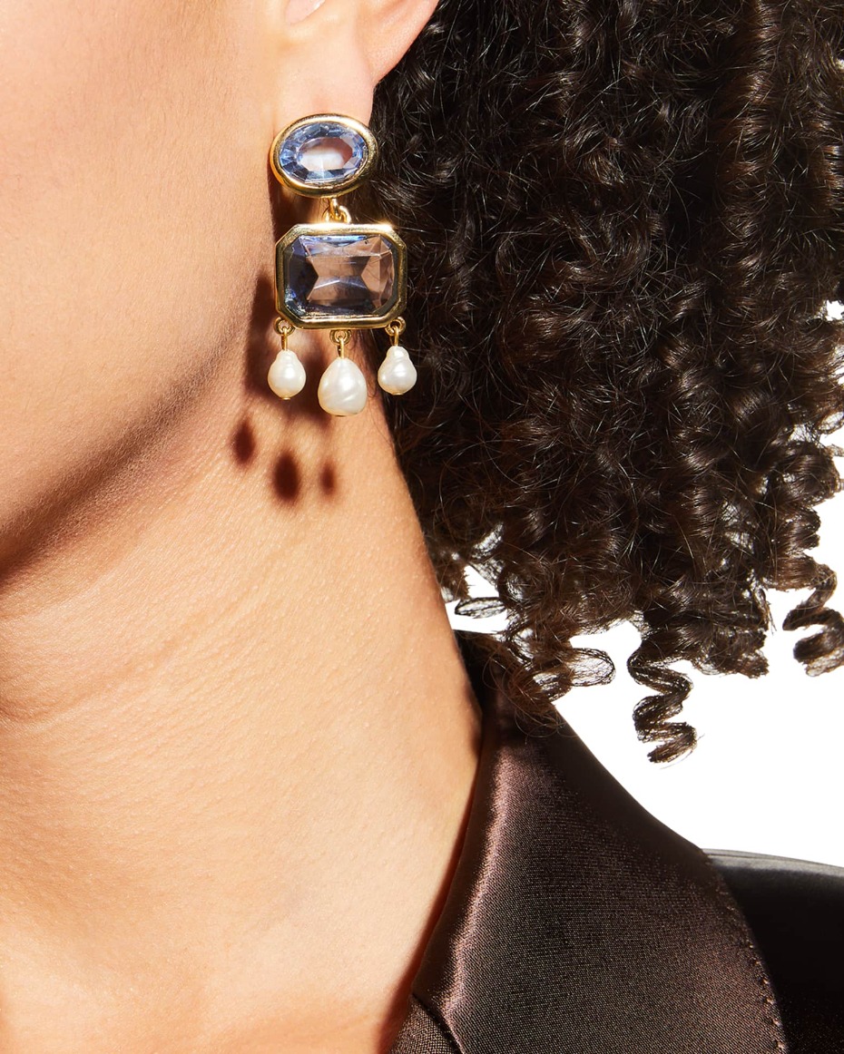 Elegant blue gemstone earrings with pearl drops on display