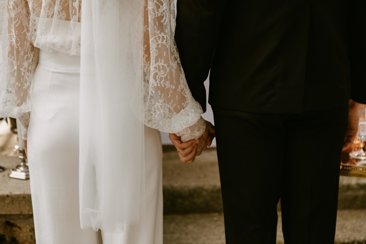 Bride and groom holding hands, walking towards their future together
