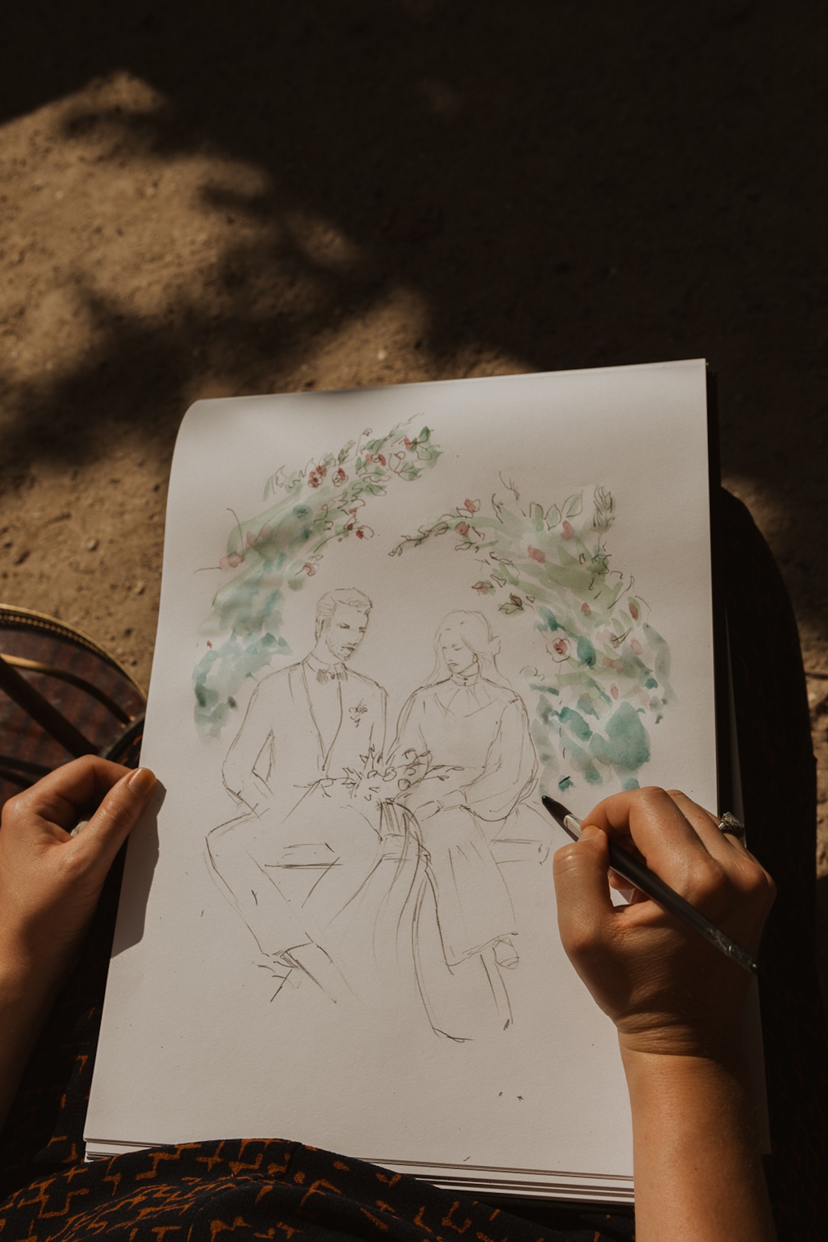 Artist sketching a wedding couple illustration with watercolor
