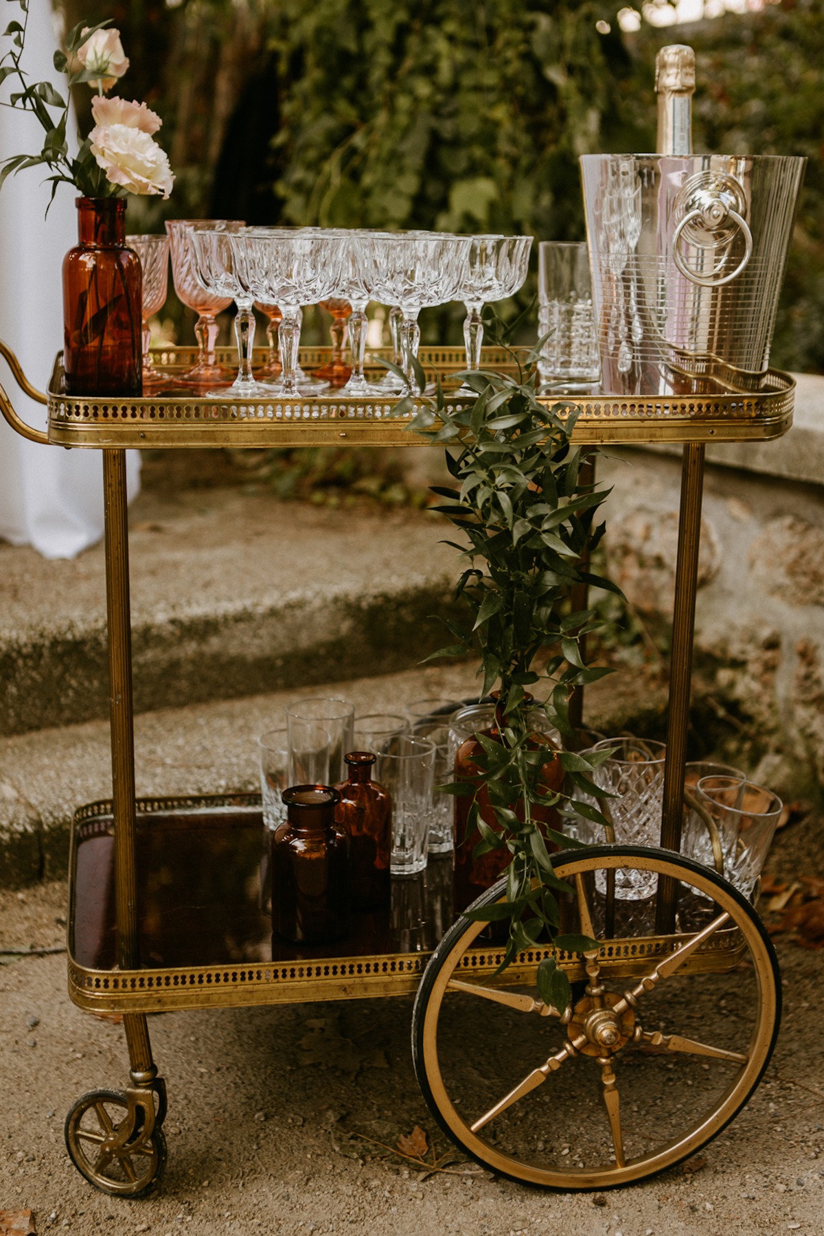 Elegant bar cart with glasses, champagne, and floral decorations