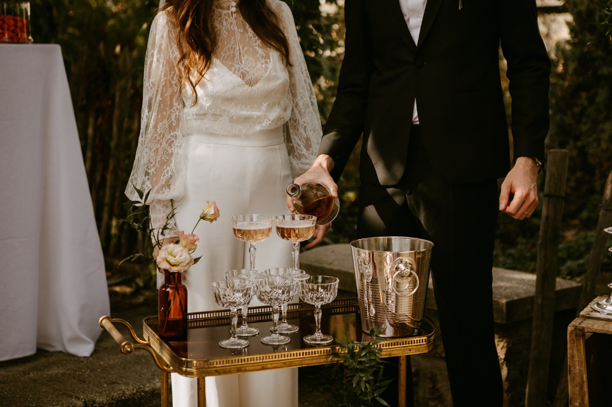 Wedding couple pouring drinks for a toast, intimate moment