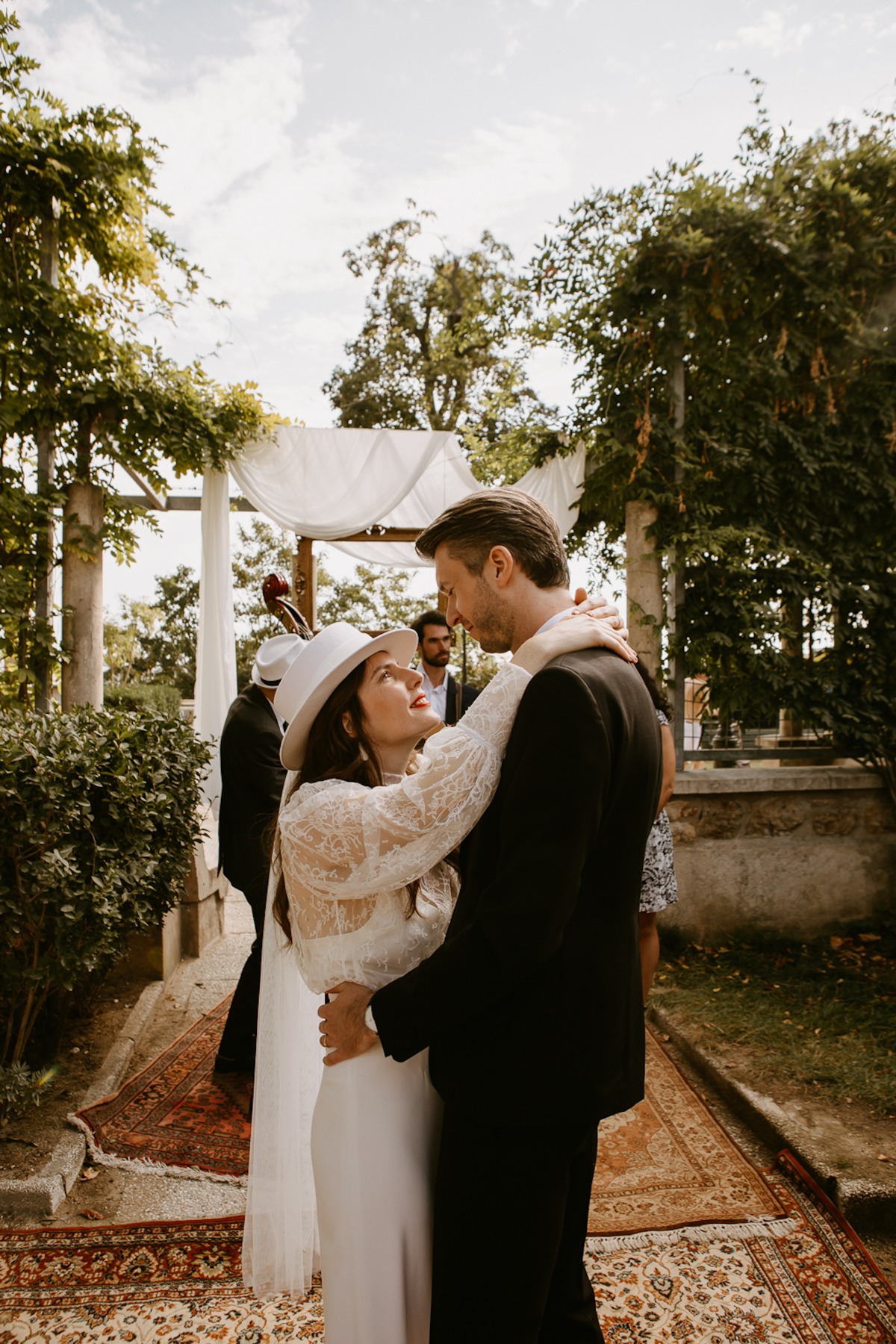 Bride and groom embracing during an outdoor wedding ceremony