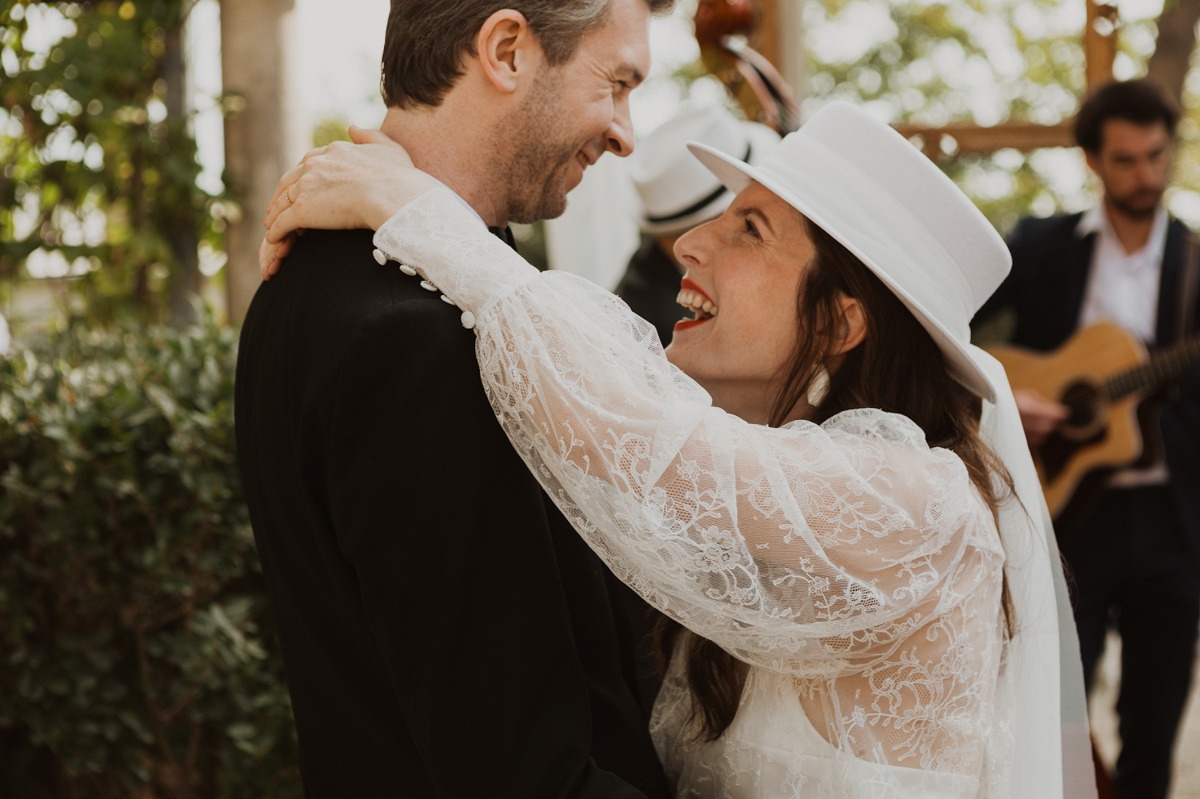Bride and groom share a joyful embrace during a wedding ceremony