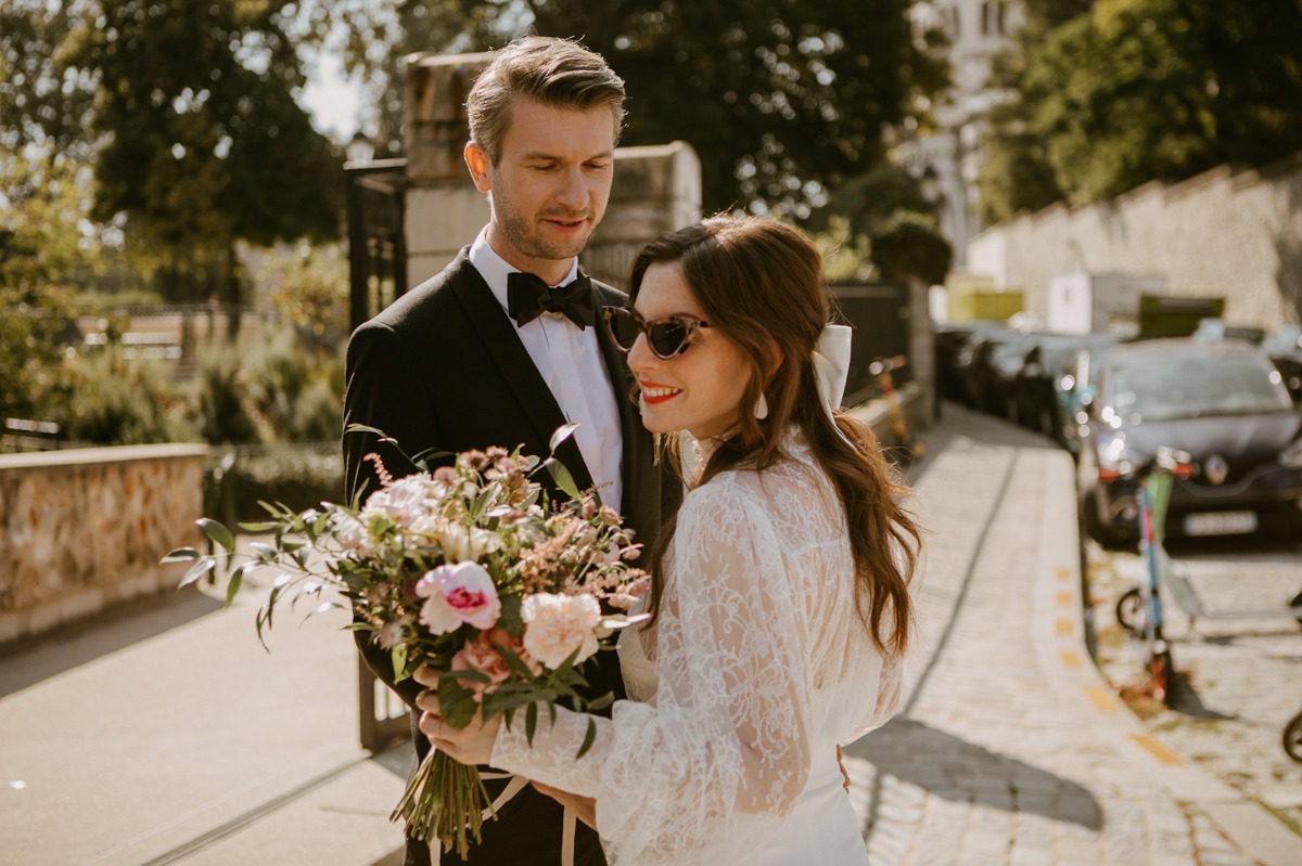 Happy couple celebrating their wedding day with a beautiful bouquet