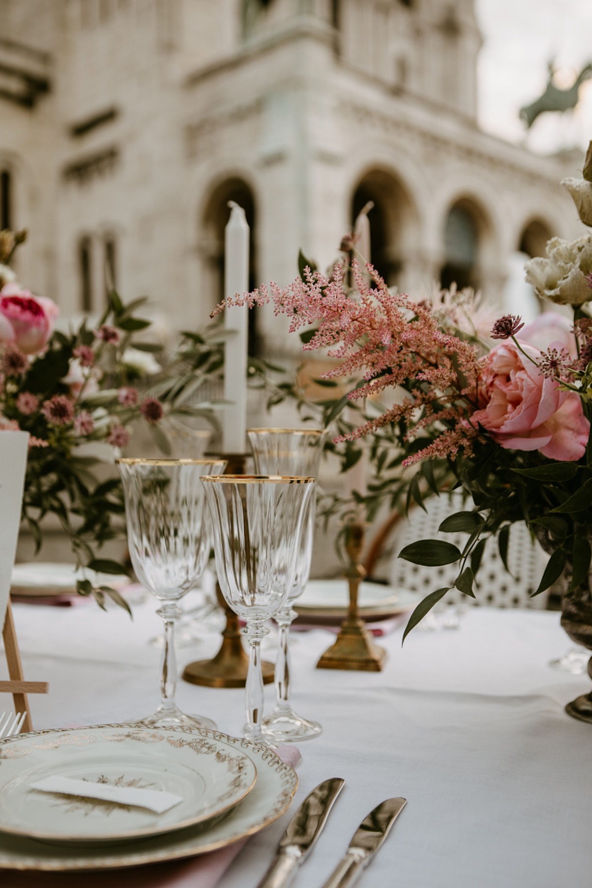 Elegant wedding table setting with floral arrangements and glasses