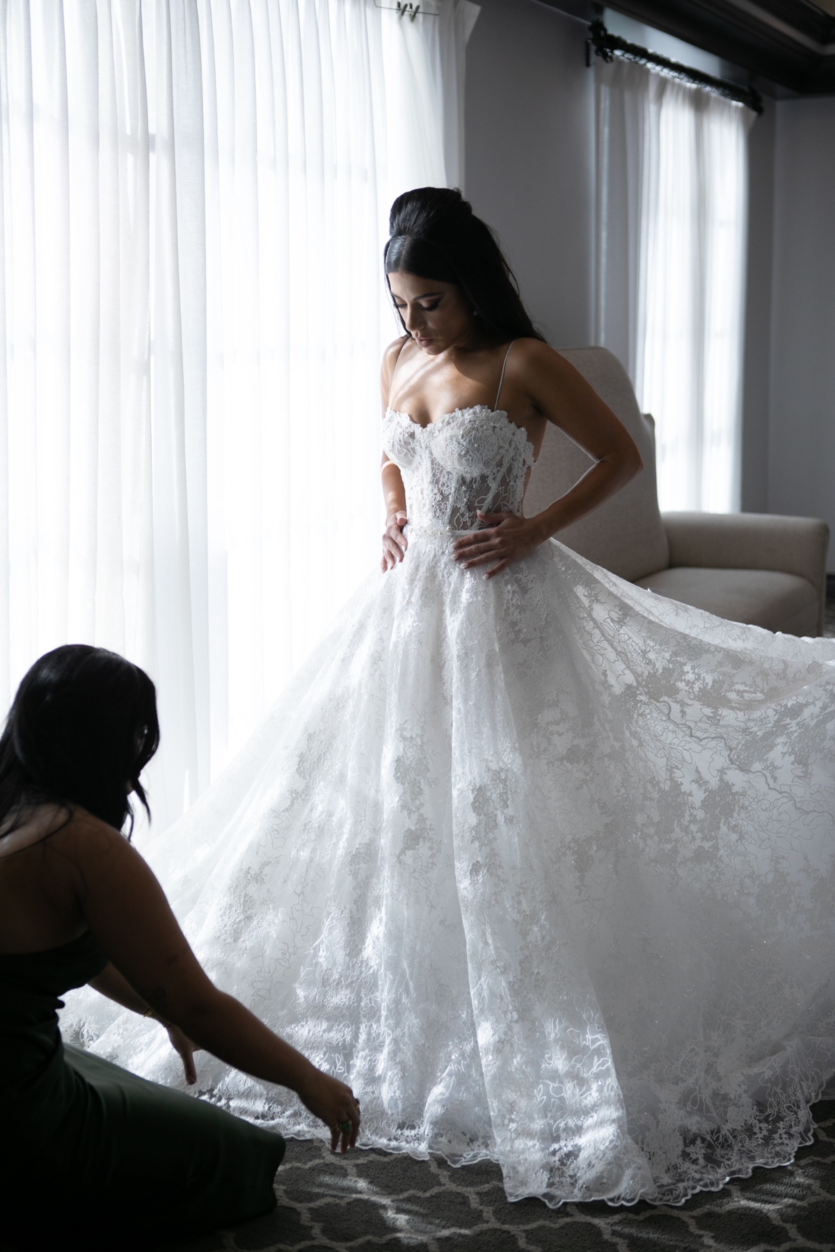 Bride getting ready in a stunning lace wedding dress