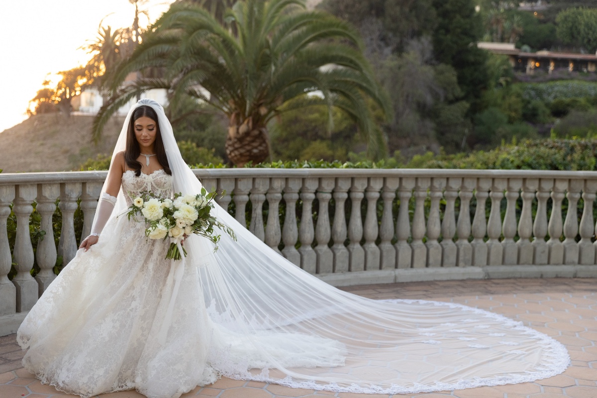 Elegant bride in a beautiful wedding dress, veil, holding a bouquet