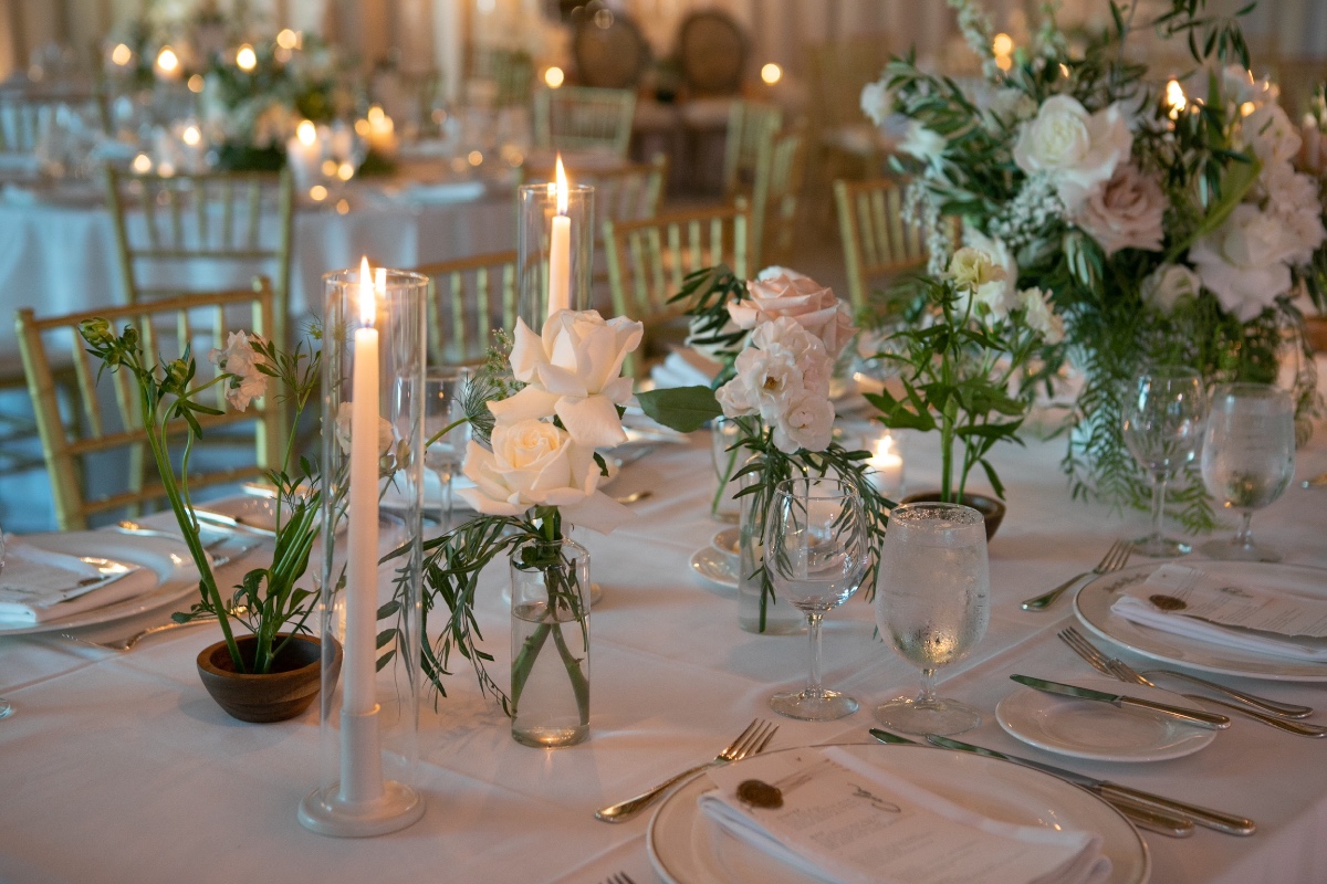 Elegant wedding table setting with candles and floral centerpieces
