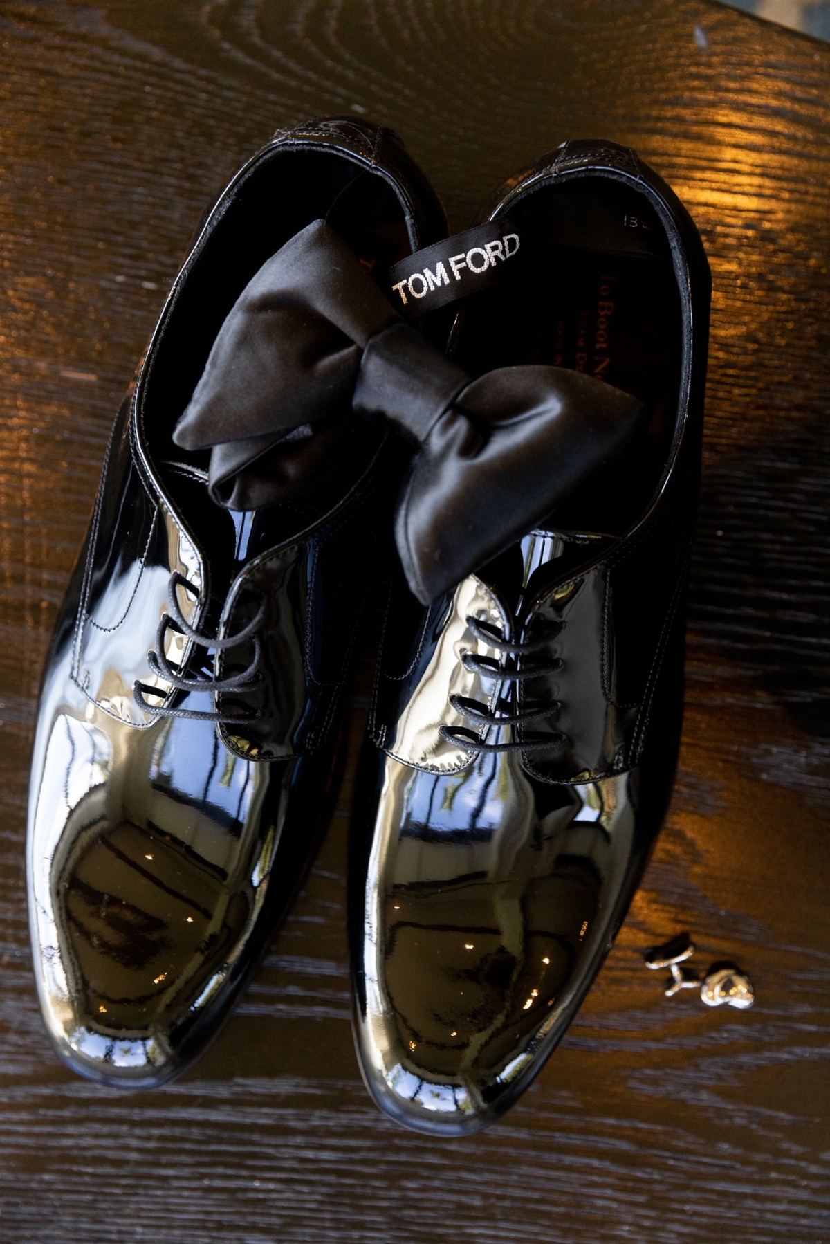 Elegant black shoes with bow tie and cufflinks, wedding details