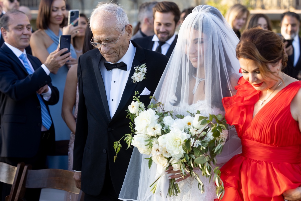 Bride walking down the aisle with her father at her wedding ceremony