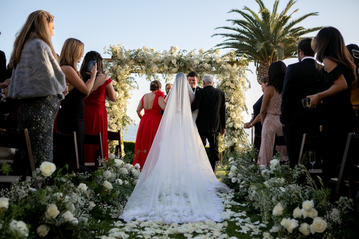 Bride walks down aisle in a beautiful outdoor wedding ceremony