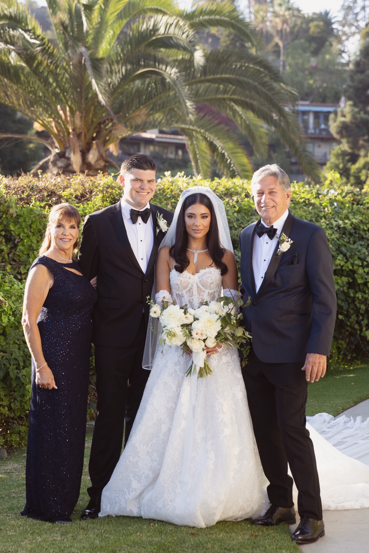 Bride and Groom pose with family on their wedding day