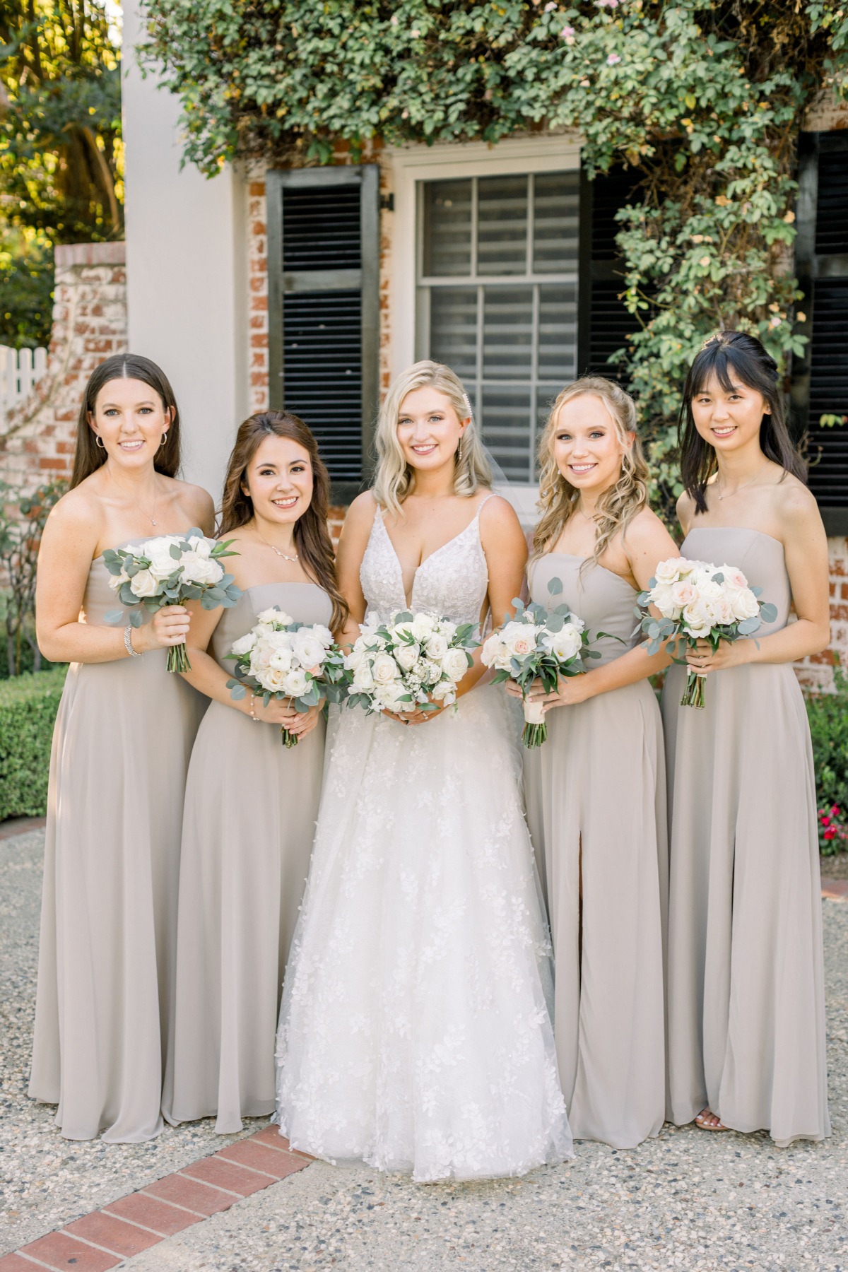 Bride and bridesmaids in elegant gray dresses outside