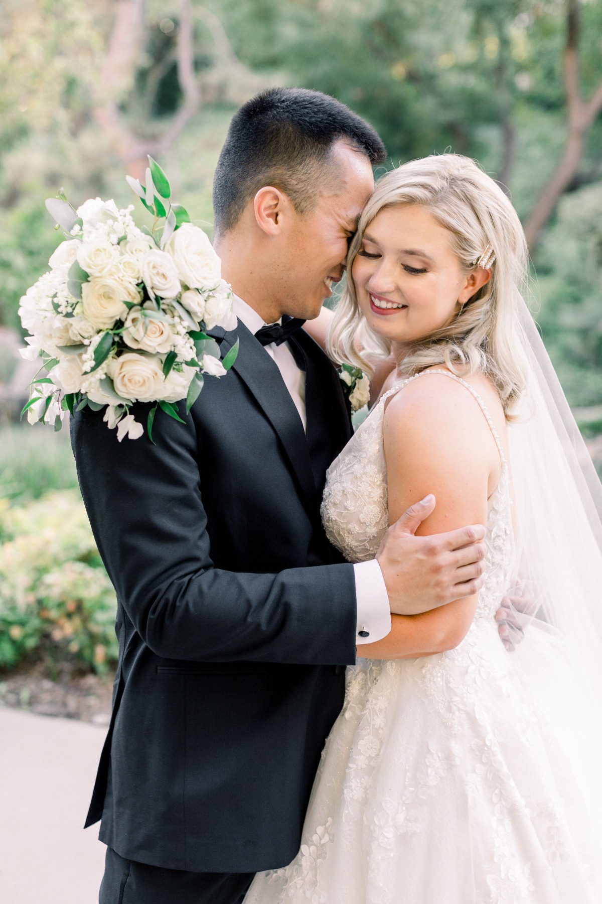 Smiling bride and groom embrace on their wedding day