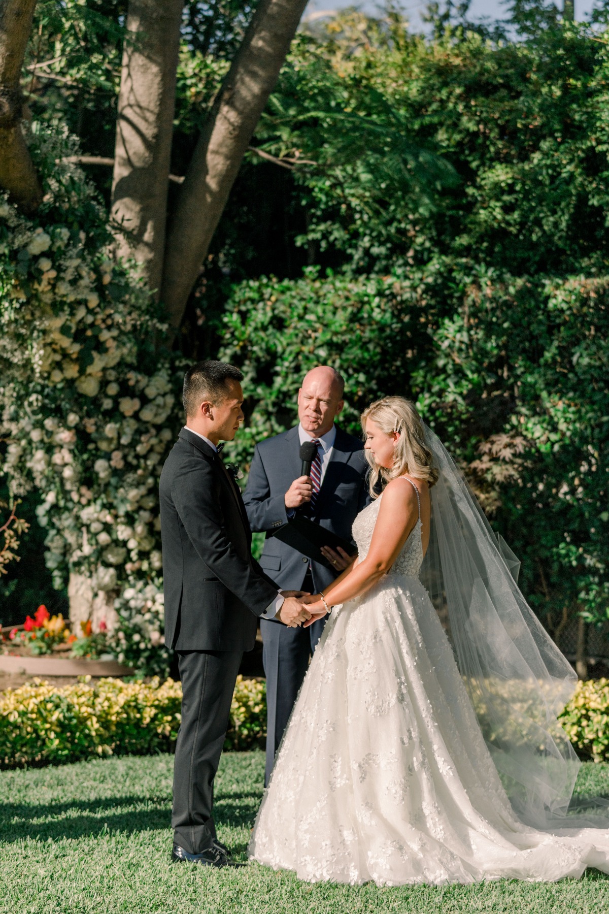Bride and groom holding hands during wedding ceremony