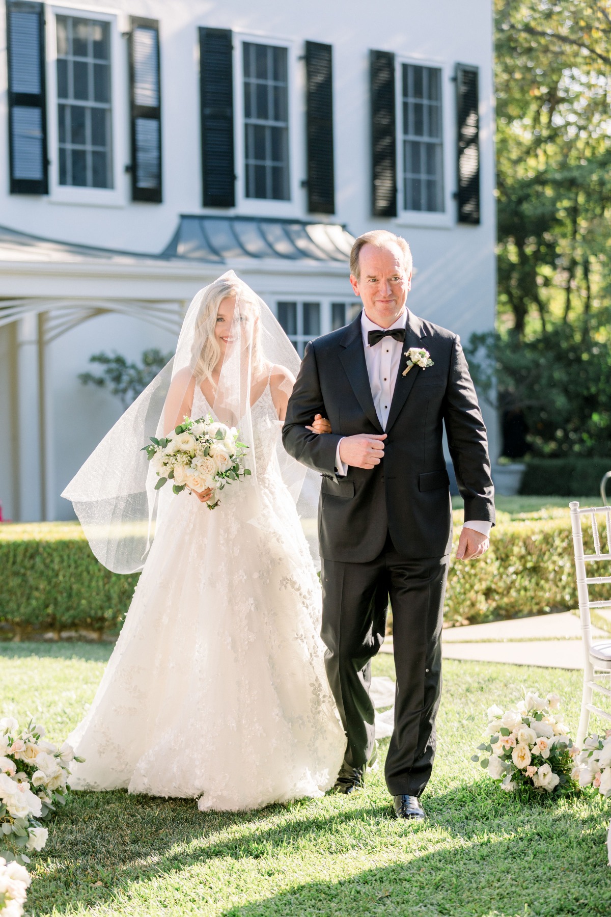 Bride walks with her father down the aisle at wedding