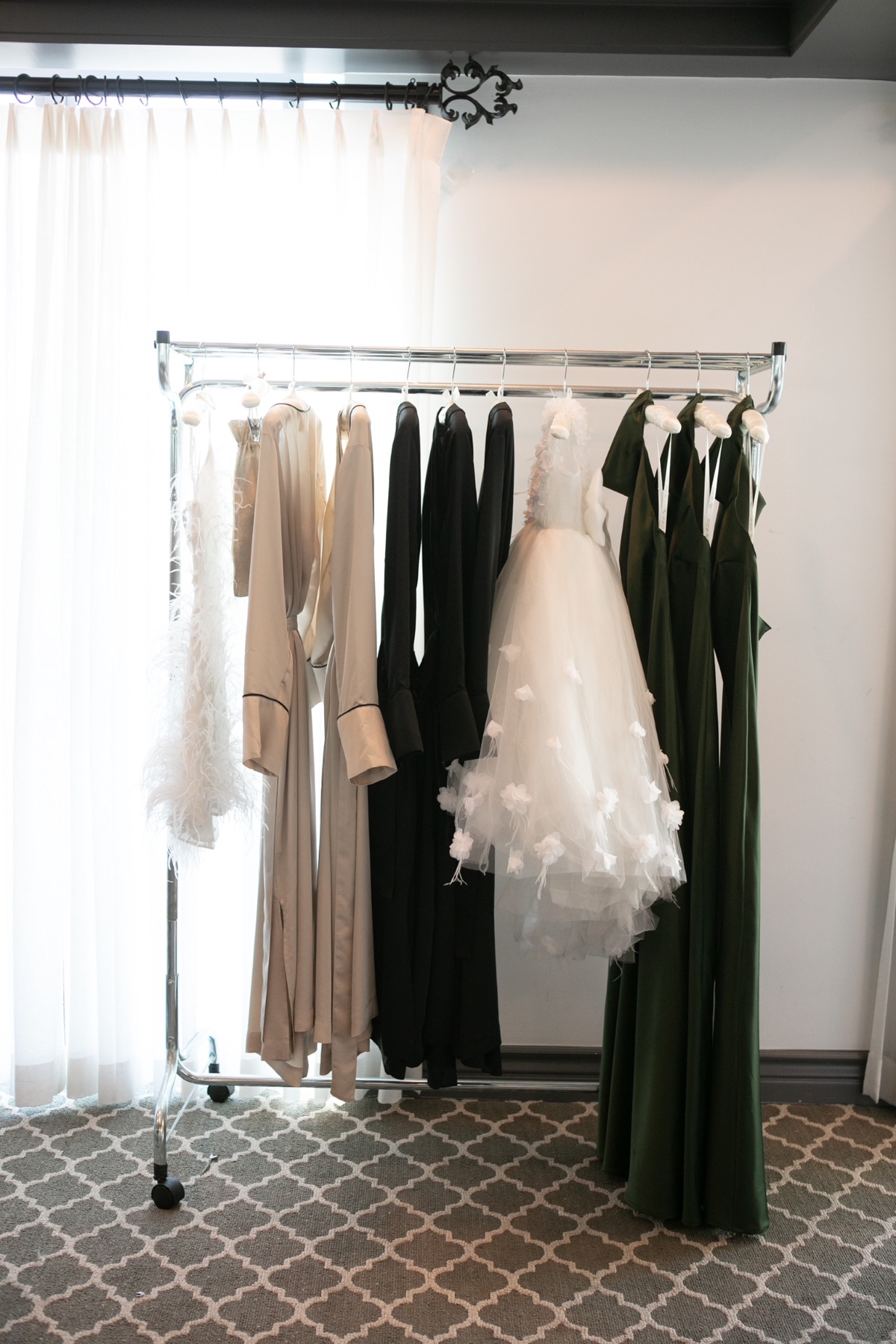 Rack of elegant gowns and dresses in various colors