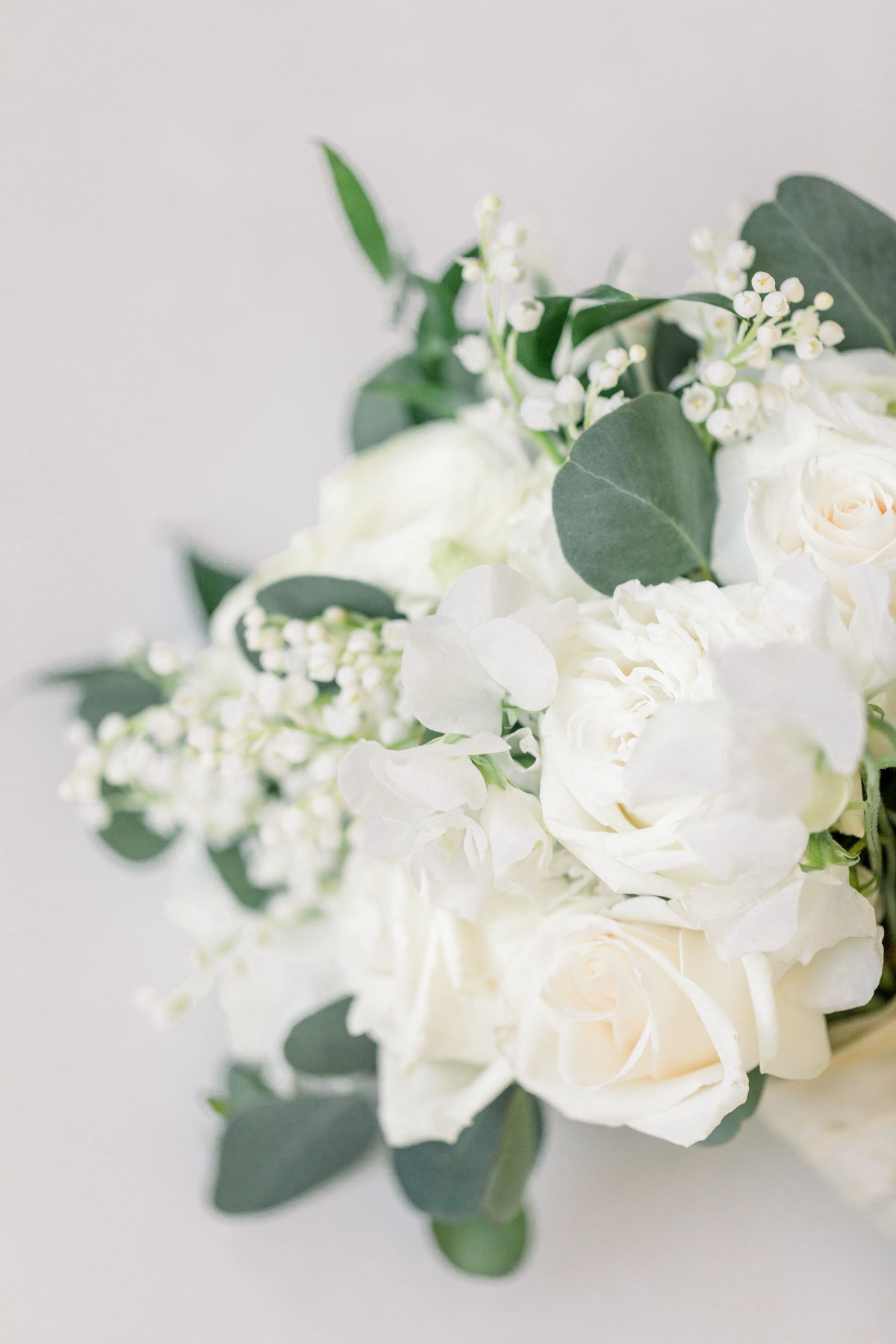 Elegant white wedding bouquet with roses and lilies