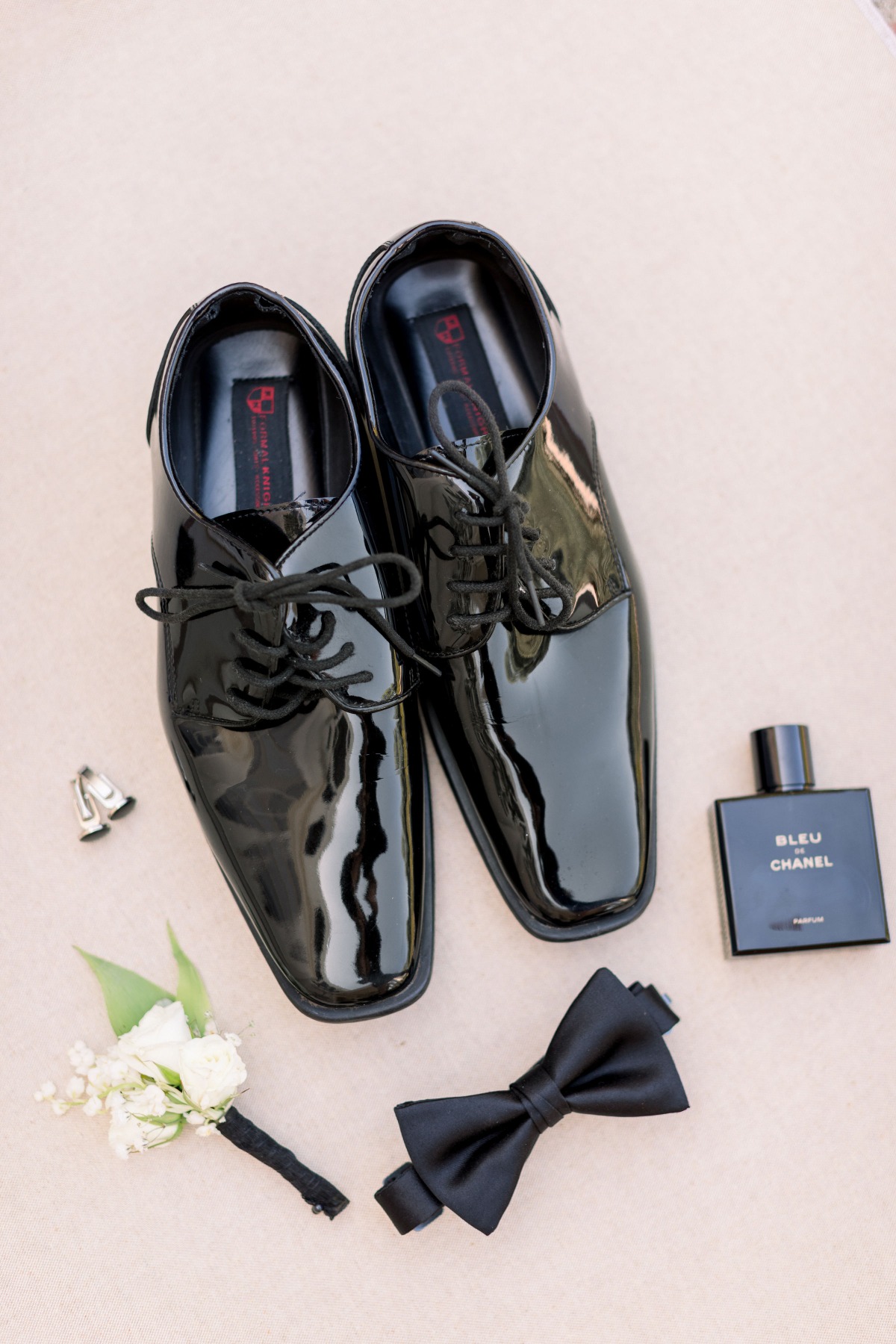 Grooms wedding day accessories including shoes and cologne