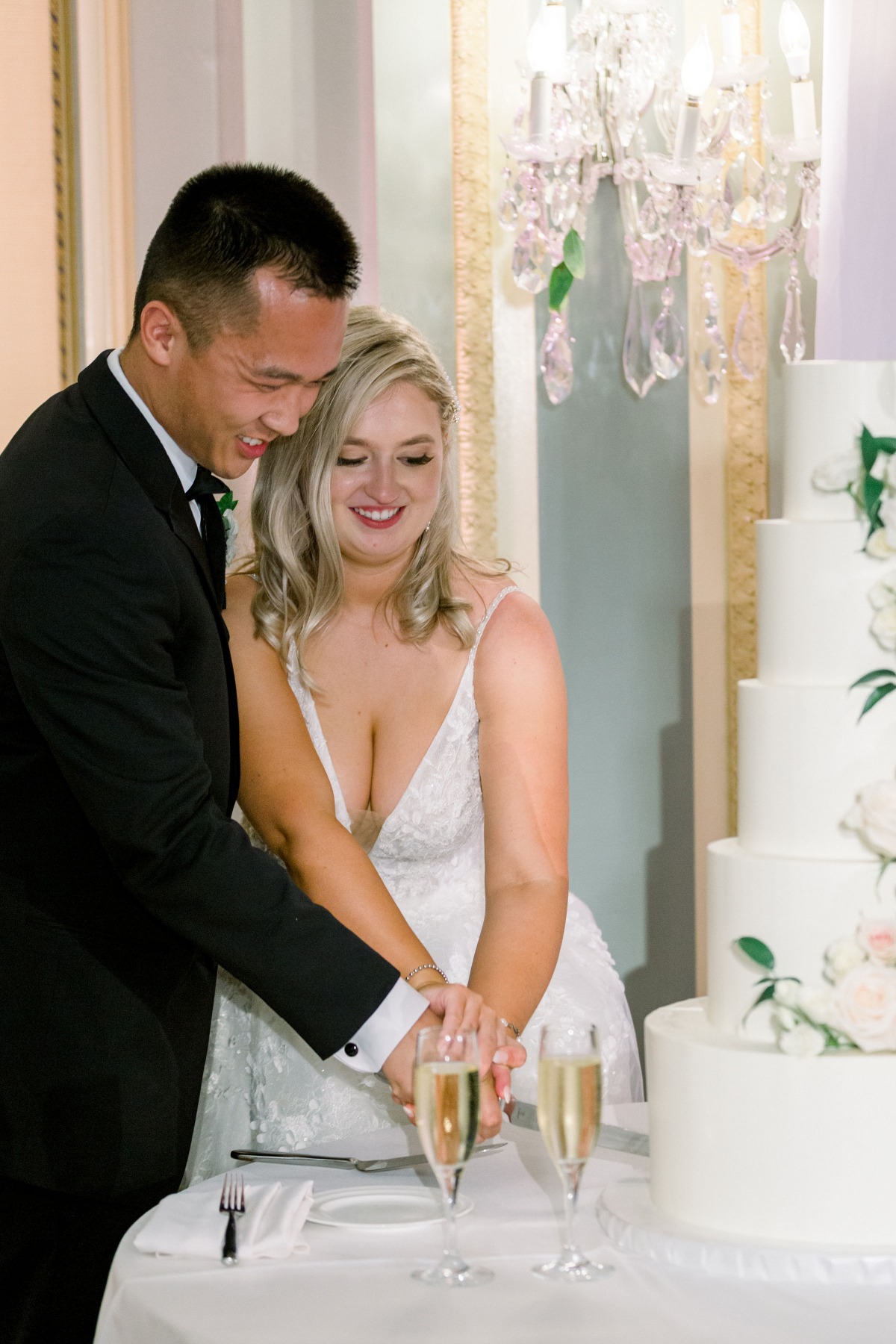 Bride and groom cutting their wedding cake smiling