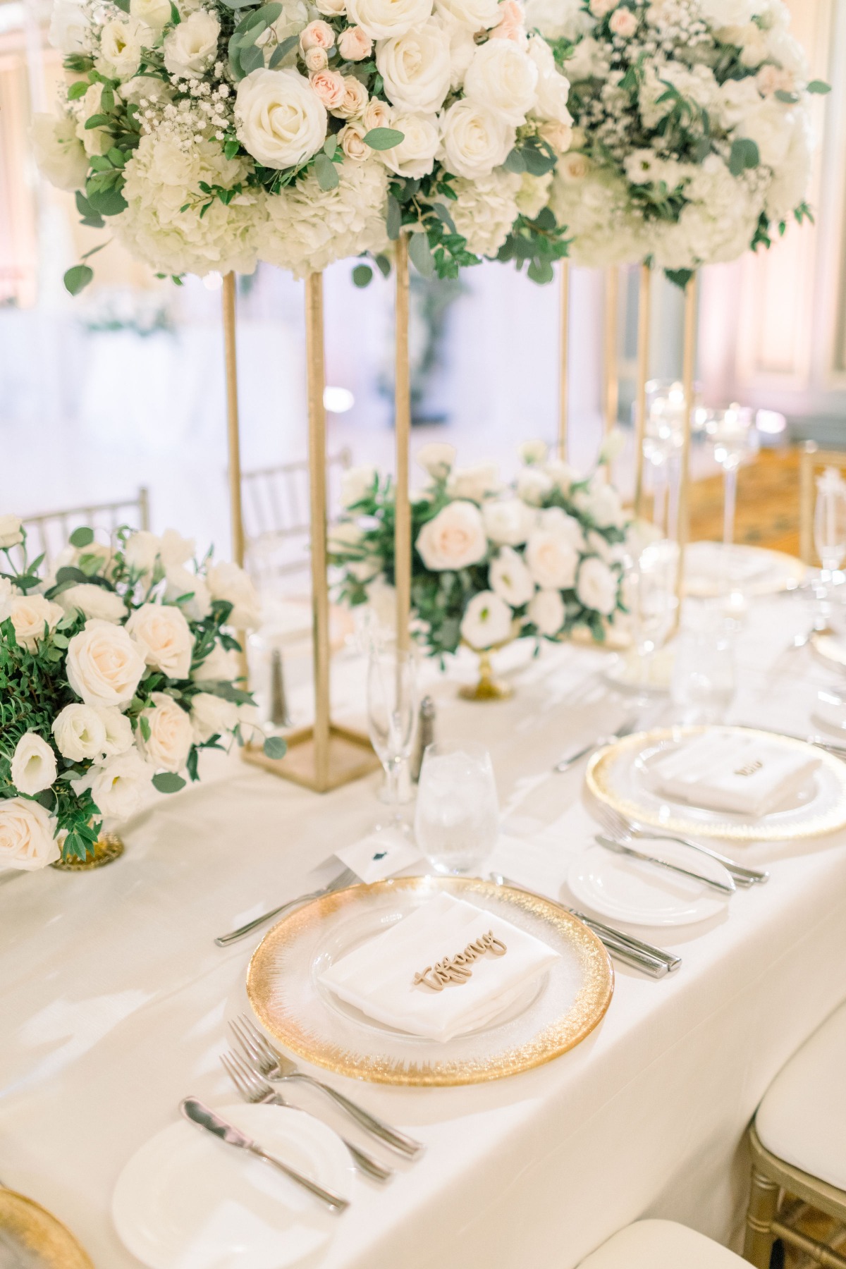 Elegant wedding table setting with white floral centerpieces