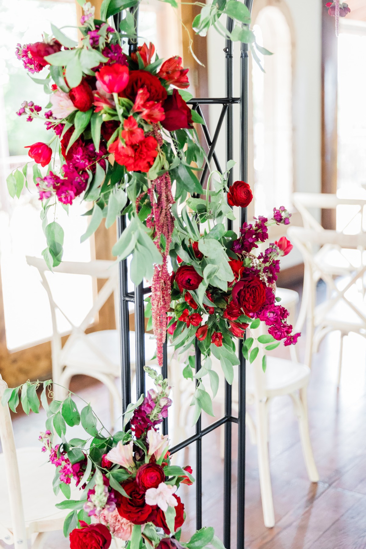 Elegant floral arrangement with vibrant red and pink flowers