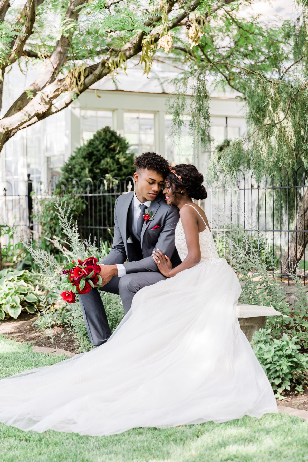 Romantic wedding couple embraces in a garden setting