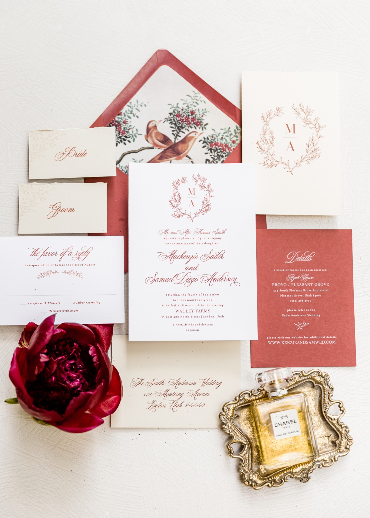 Elegant wedding invitation suite with floral details and perfume