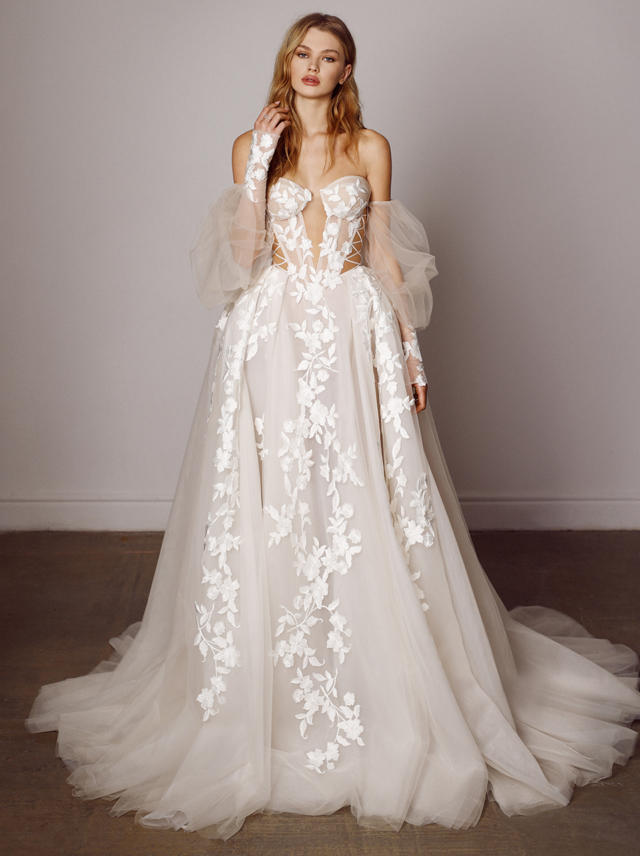 Elegant bride in a floral wedding dress with detachable sleeves