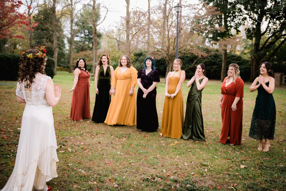 Bride surprises bridesmaids with a beautiful reveal in garden setting