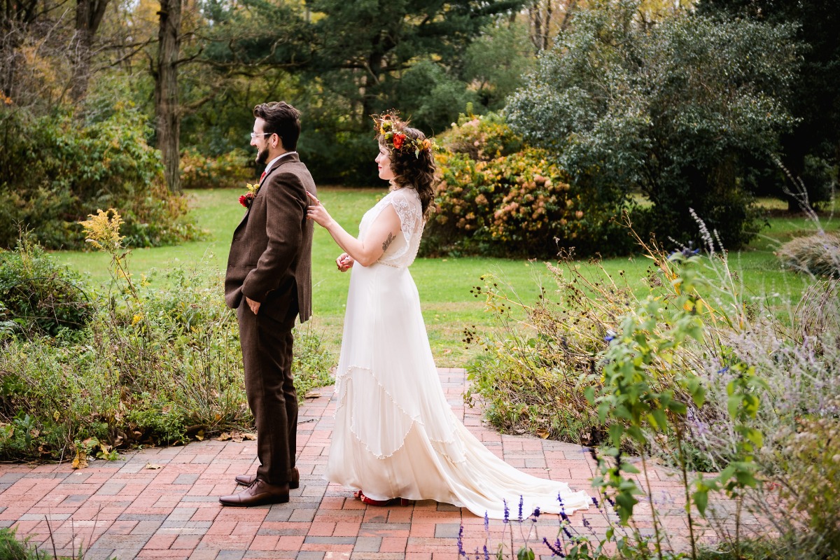 Bride touching grooms shoulder during their wedding day first look