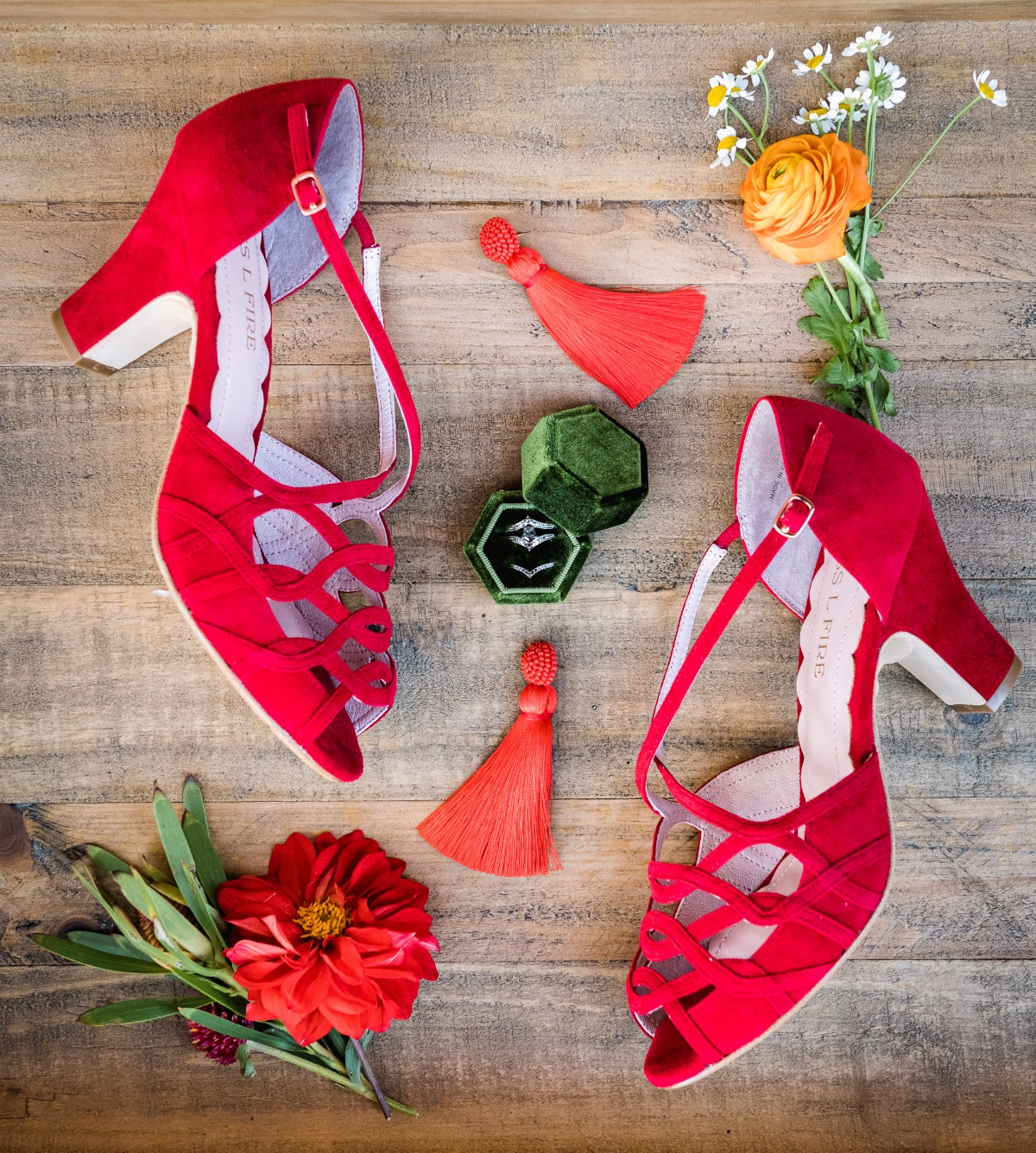 Red wedding shoes with engagement ring and floral details