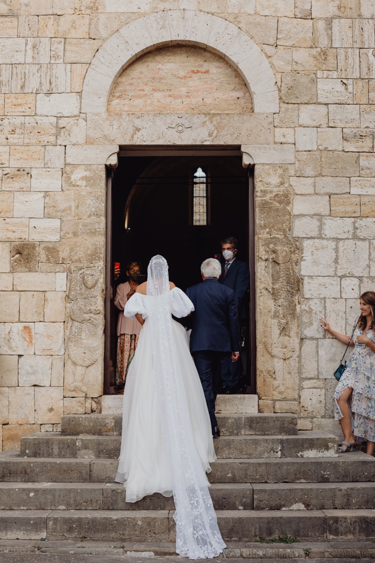 Bride entering a church with her father on her wedding day