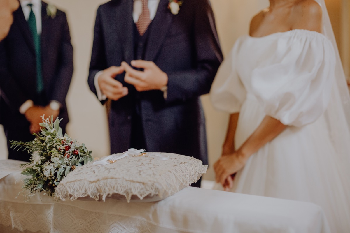 Wedding ceremony with bride and groom near a ring pillow
