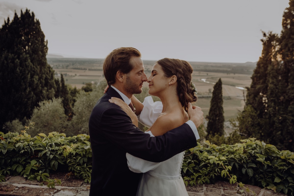 Newlyweds share a tender moment overlooking a stunning landscape