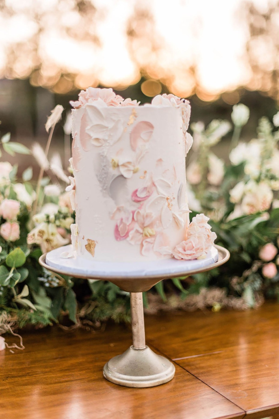 Elegant wedding cake with floral design and golden accents