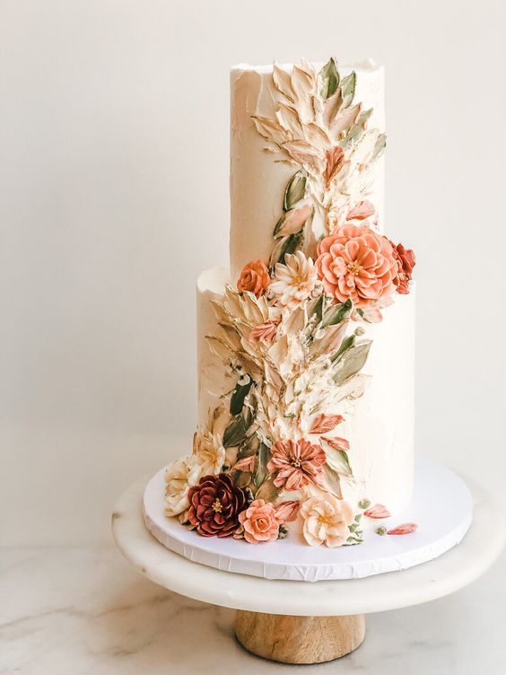 Two tier cake decorated with buttercream flowers