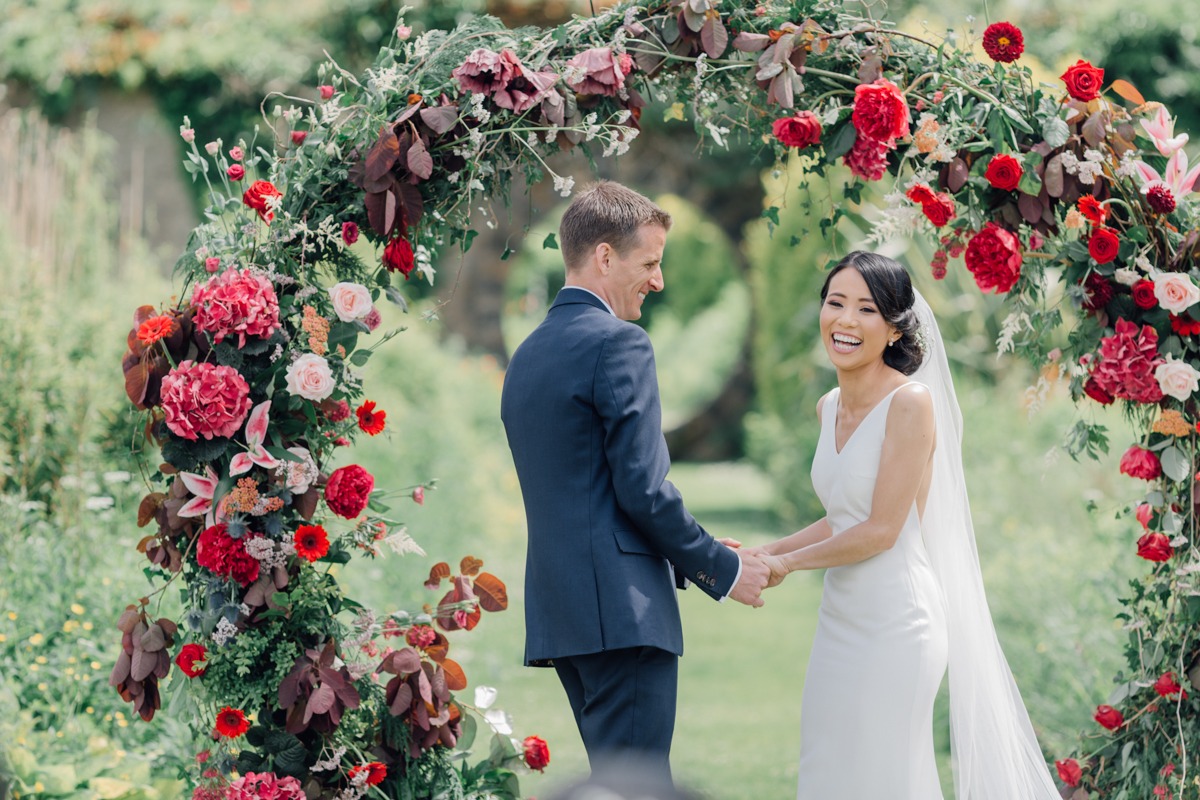 Beautiful Garden Ceremony And A Flower Arch With Blooms As Big As Your Head
